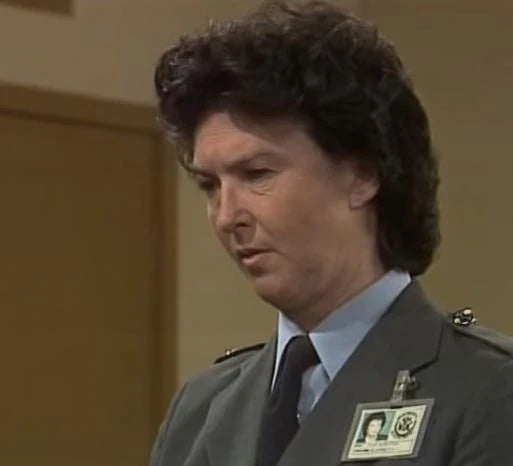 Delva Hunter in uniform with a name tag against a plain background