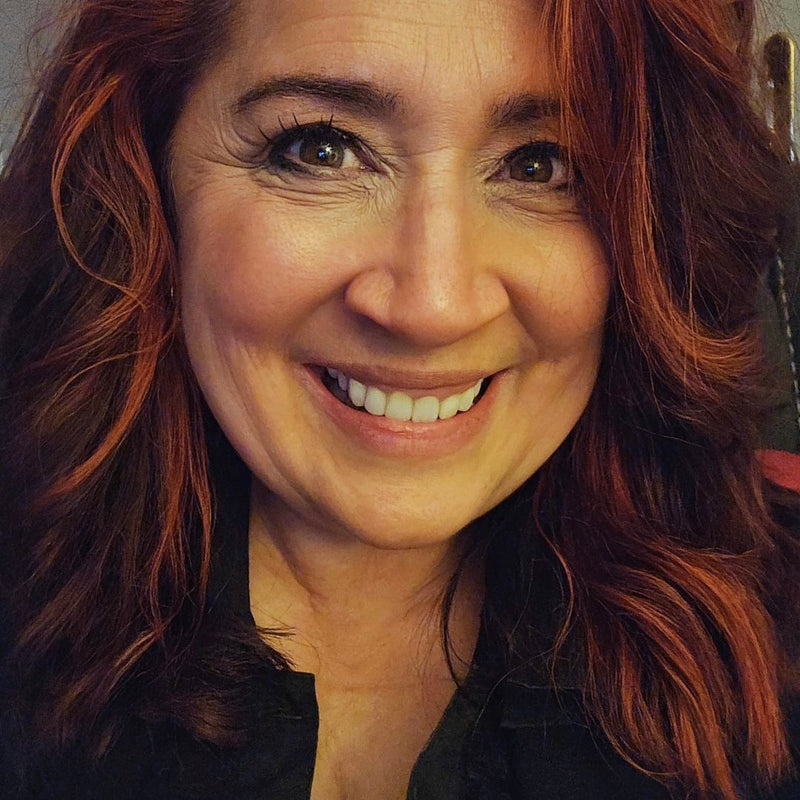Close-up of a woman with red hair smiling