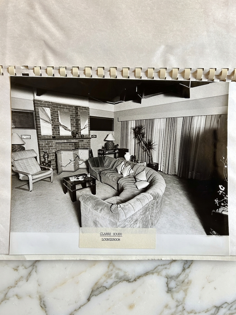 Vintage black and white photo of a living room with modern furniture on a marble surface.