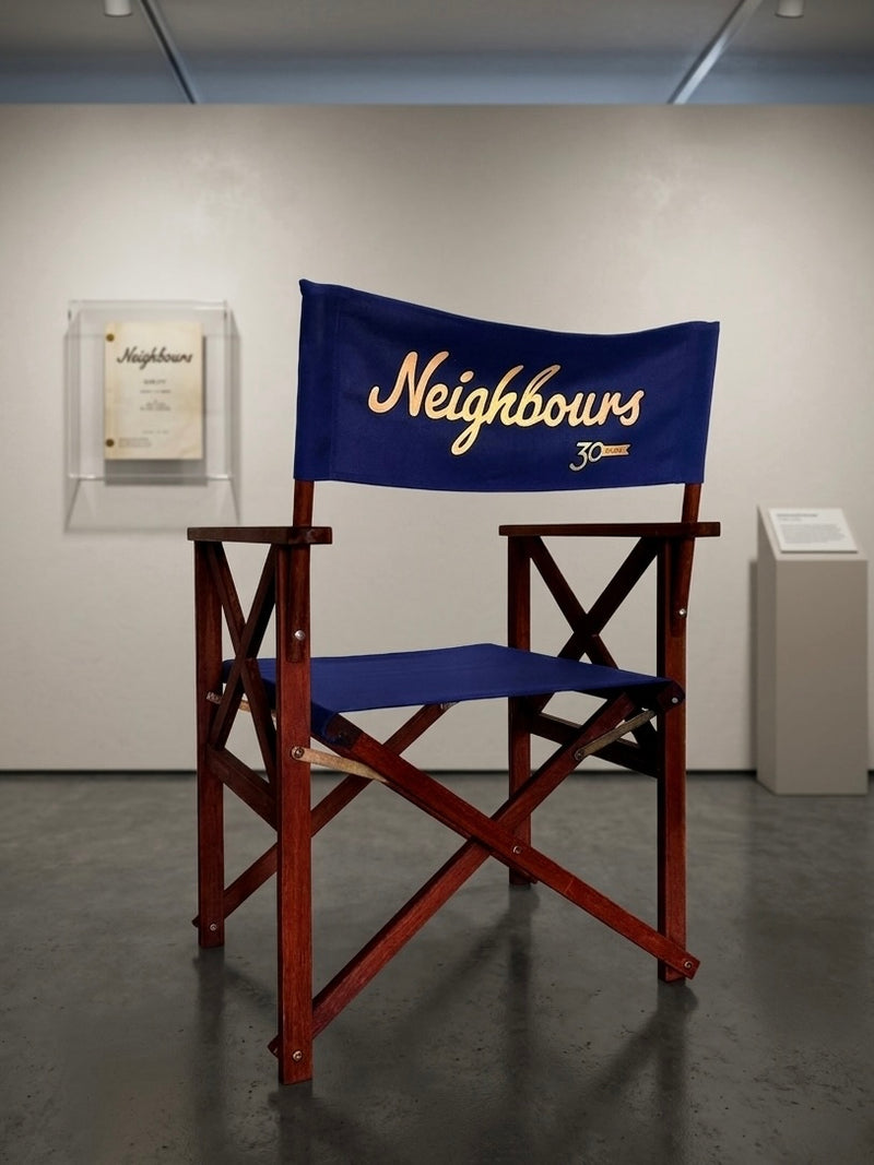 Director's chair with 'Neighbours' logo in a room setting