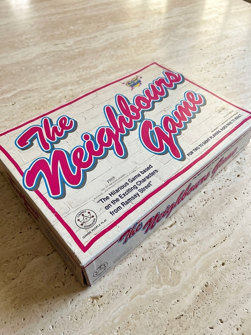 Box of 'The Neighbours Game' on a light-colored surface