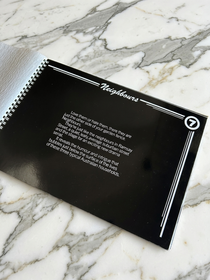 Black book or notebook with text on a marble surface
