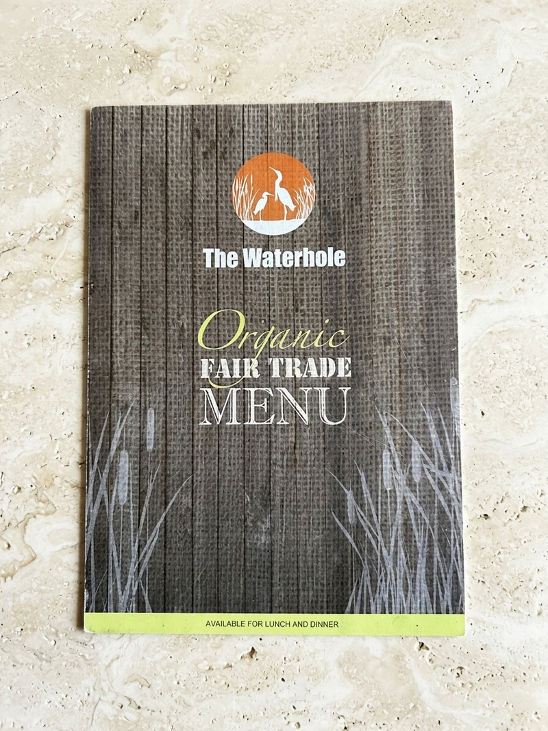 Organic Fair Trade menu from The Waterhole on a textured surface