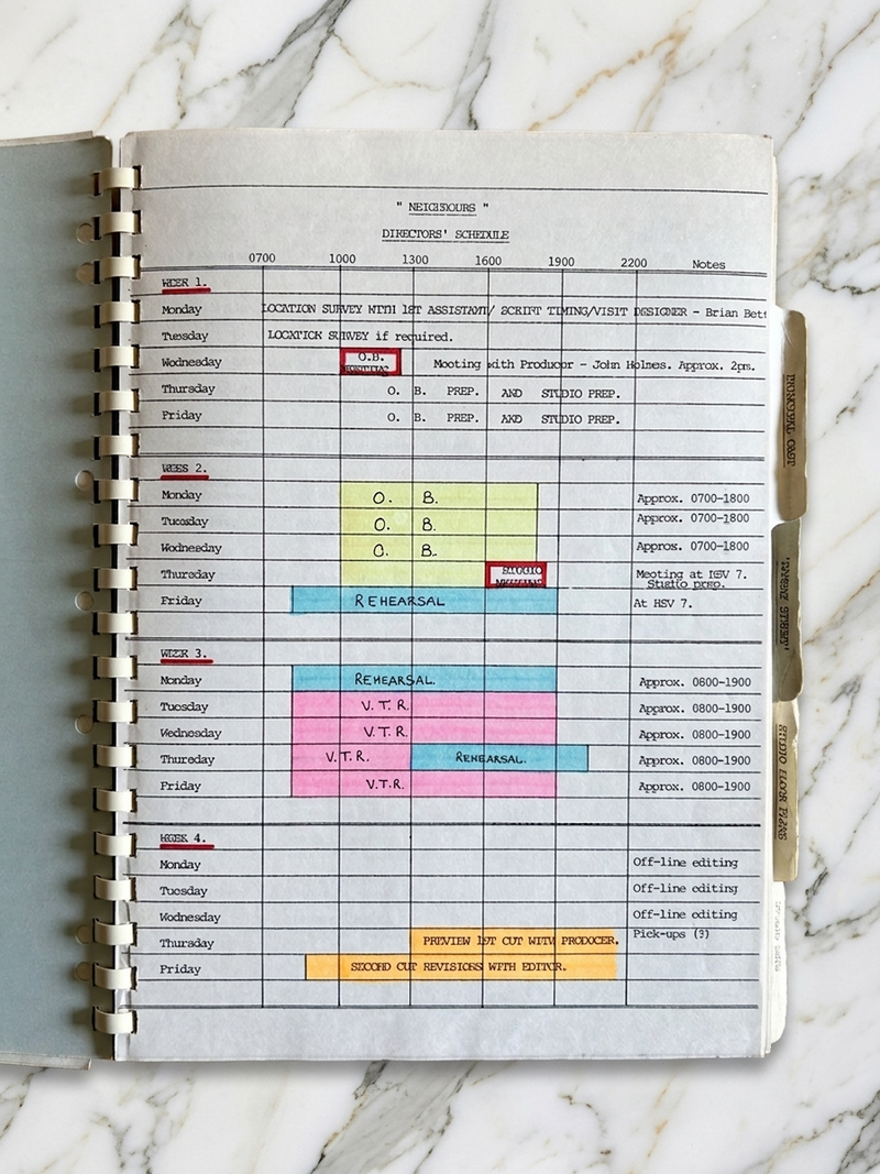Scheduler with colorful notes on a marble surface