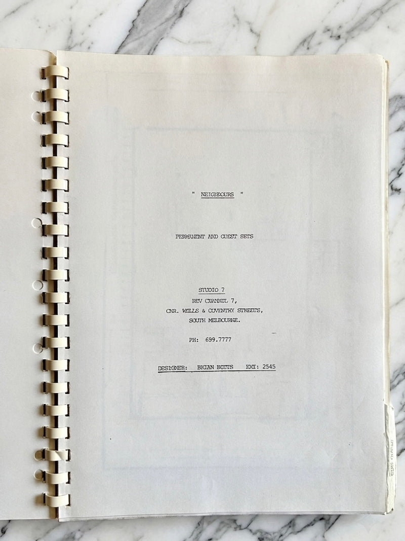 Spiral-bound notebook with text on a marble surface