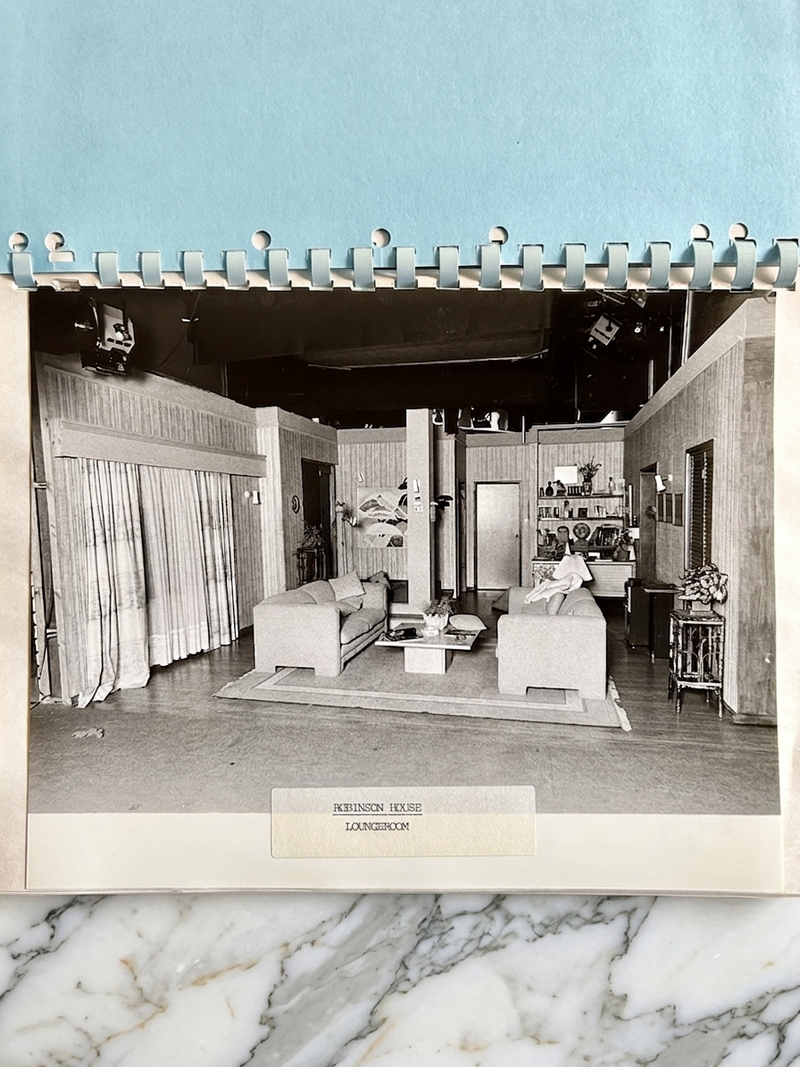 Vintage interior design photo of a living room with a blue border and marble base.