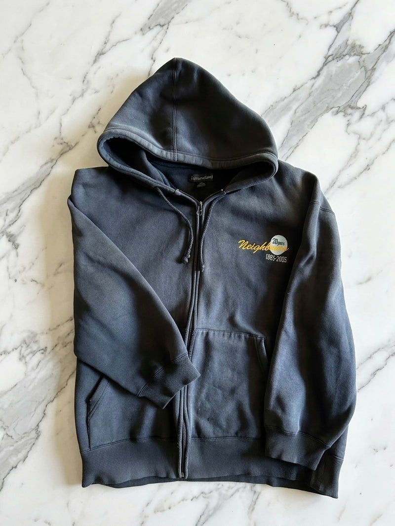 Dark gray hoodie with a logo on a marble surface
