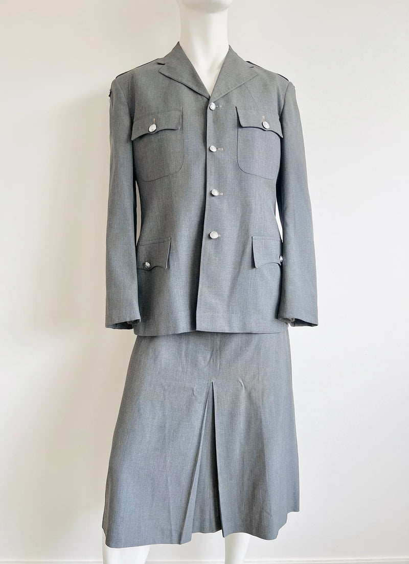 Grey prison governor uniform on a mannequin against a white background