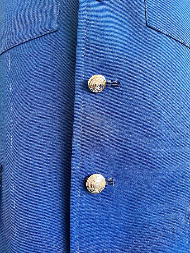 Close-up of a blue prison guard coat with gold buttons