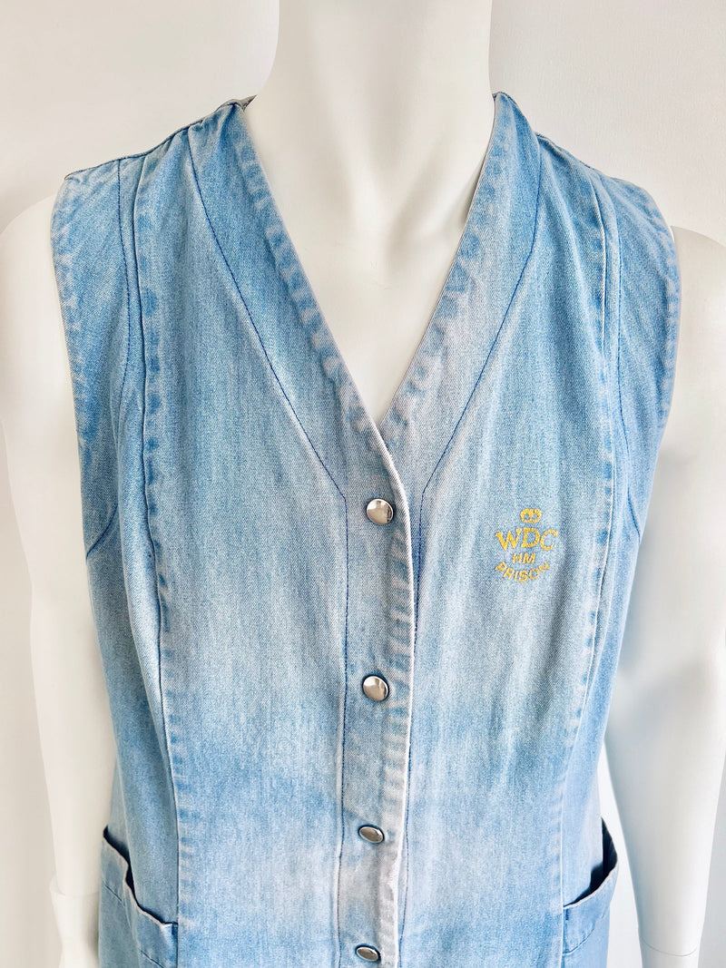 Light blue denim vest on a mannequin with a visible brand logo.
