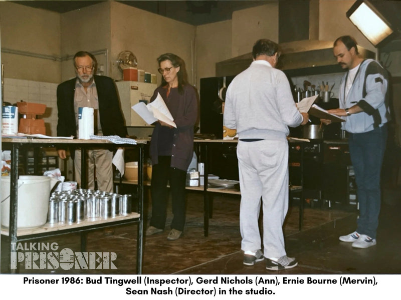 Group of people in a studio setting with equipment and documents.