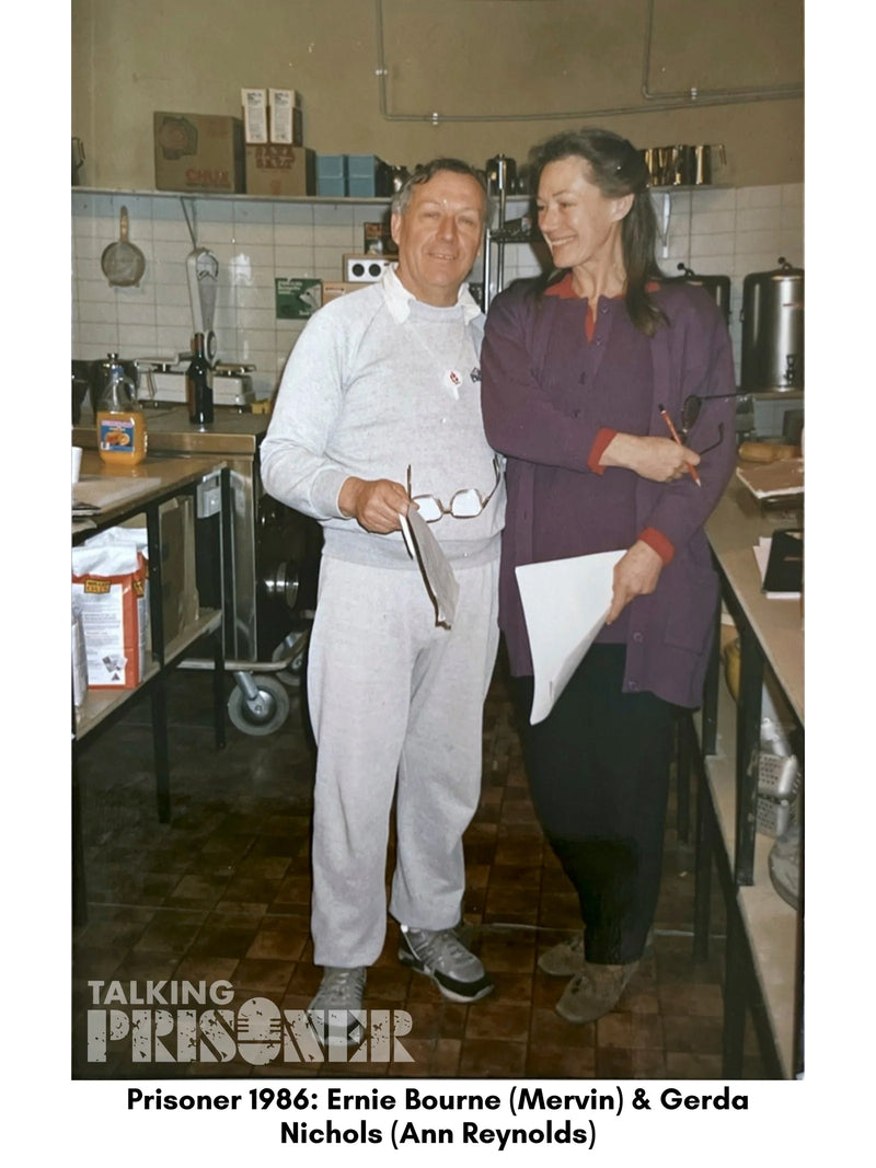 Two people standing in a kitchen, with text indicating character names.