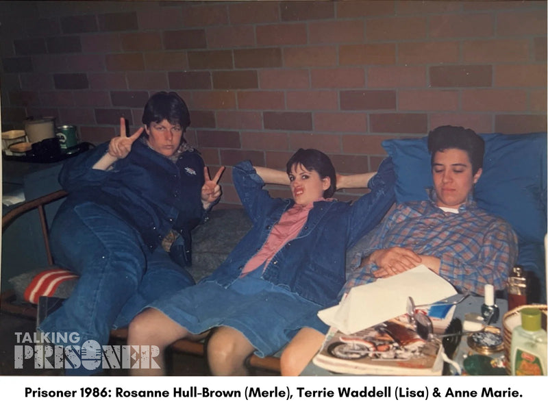 Three people sitting on a couch with a brick wall background, featuring text about 'Prisoner' 1986 with names Rosanne Hull-Brown, Terrie Waddell, and Anne Marie.