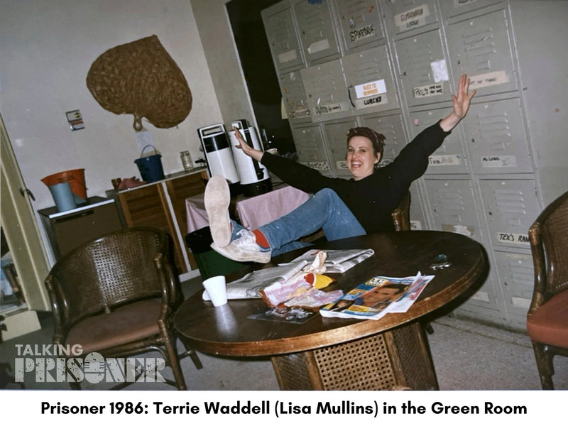 Person sitting on a table in a room with lockers and various items.
