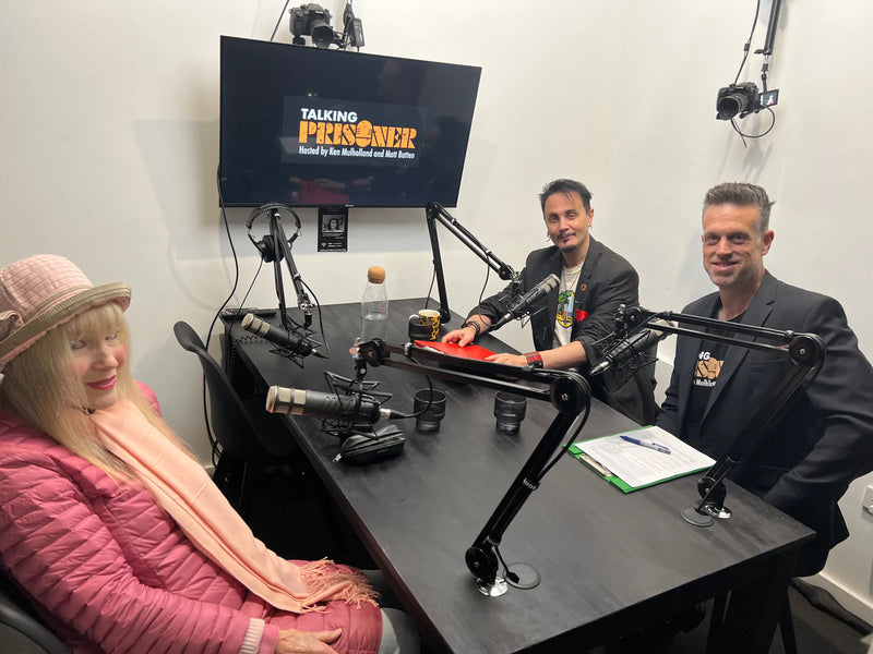 Three people in a podcast studio with microphones and a screen displaying 'Talking Prisoner'.
